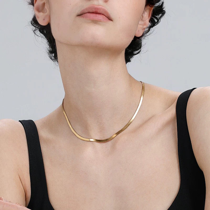 Minimalist snake chain choker Necklace waterproof displayed on model wearing a black top.